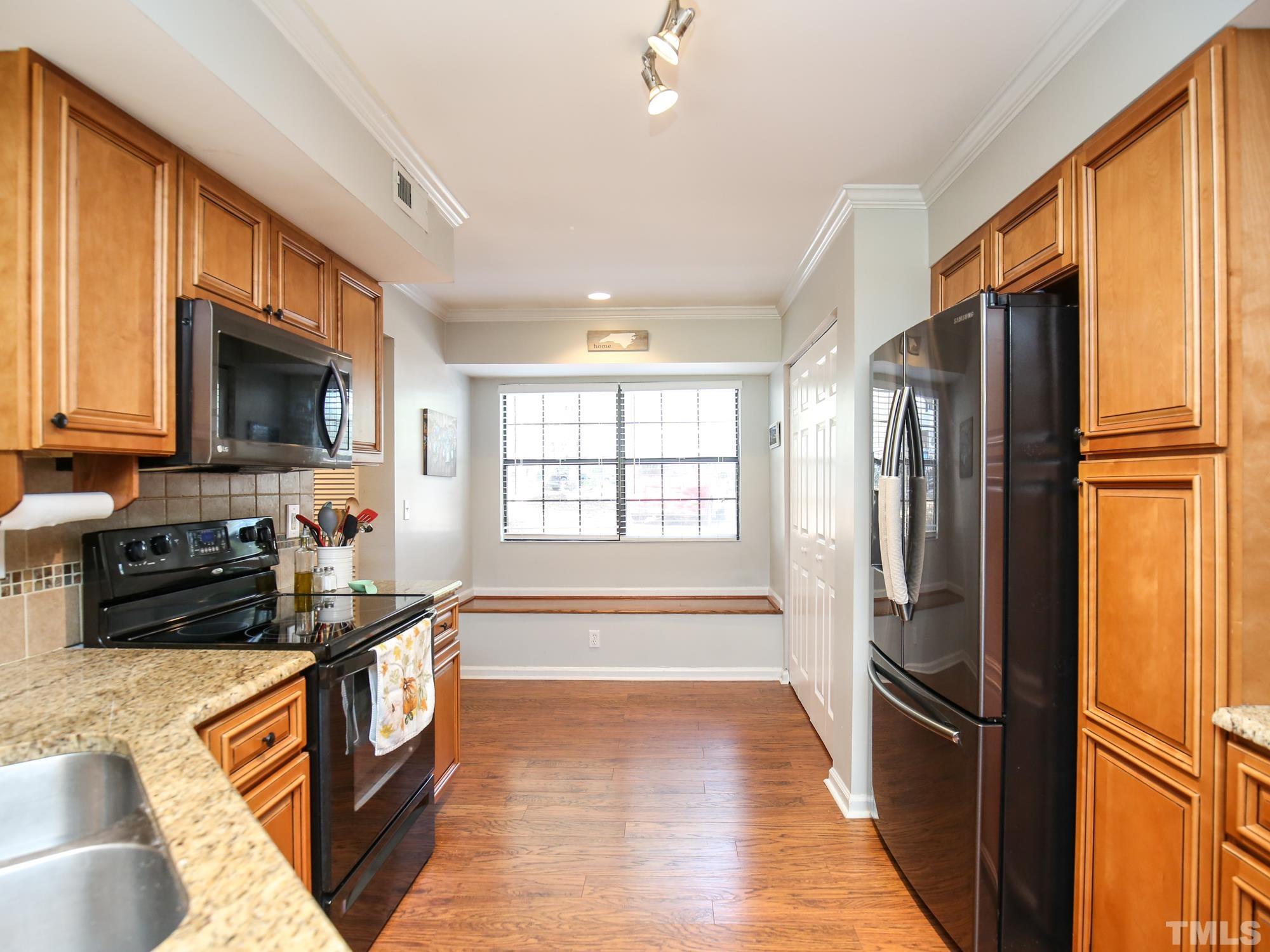 2429 Condor Court, Unit 2429 Raleigh, NC 27615 - Photo 6 of 26 a kitchen with stainless steel appliances granite countertop a refrigerator stove and sink