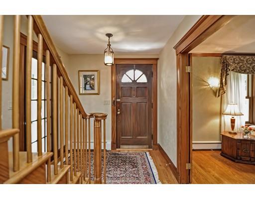 317 North Street Walpole, MA 02081 - Photo 11 of 27 a view of a hallway with a dining table and a mirror