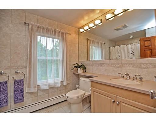 317 North Street Walpole, MA 02081 - Photo 22 of 27 a bathroom with a granite countertop sink toilet a mirror and shower