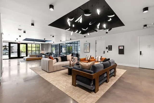 a view of a patio with couches table and chairs with potted plants