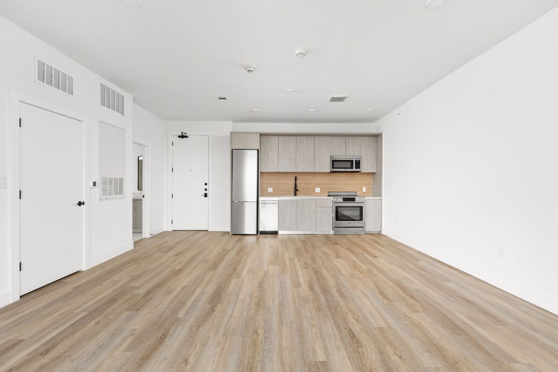 4315 South Congress Avenue, Unit 523 Austin, TX 78745 - Photo 2 of 32 a view of a kitchen with wooden floor