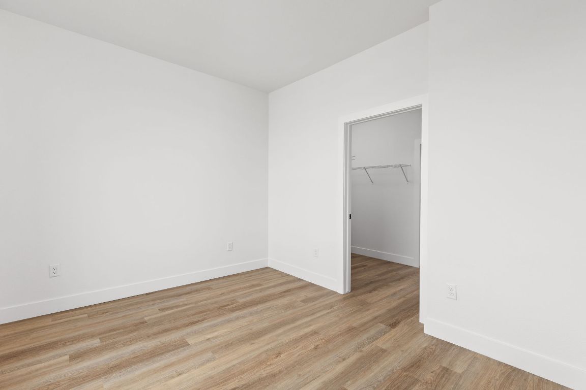4315 South Congress Avenue, Unit 523 Austin, TX 78745 - Photo 21 of 32 an empty room with wooden floor & cabinets