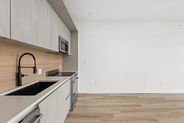 a view of kitchen with microwave and cabinets