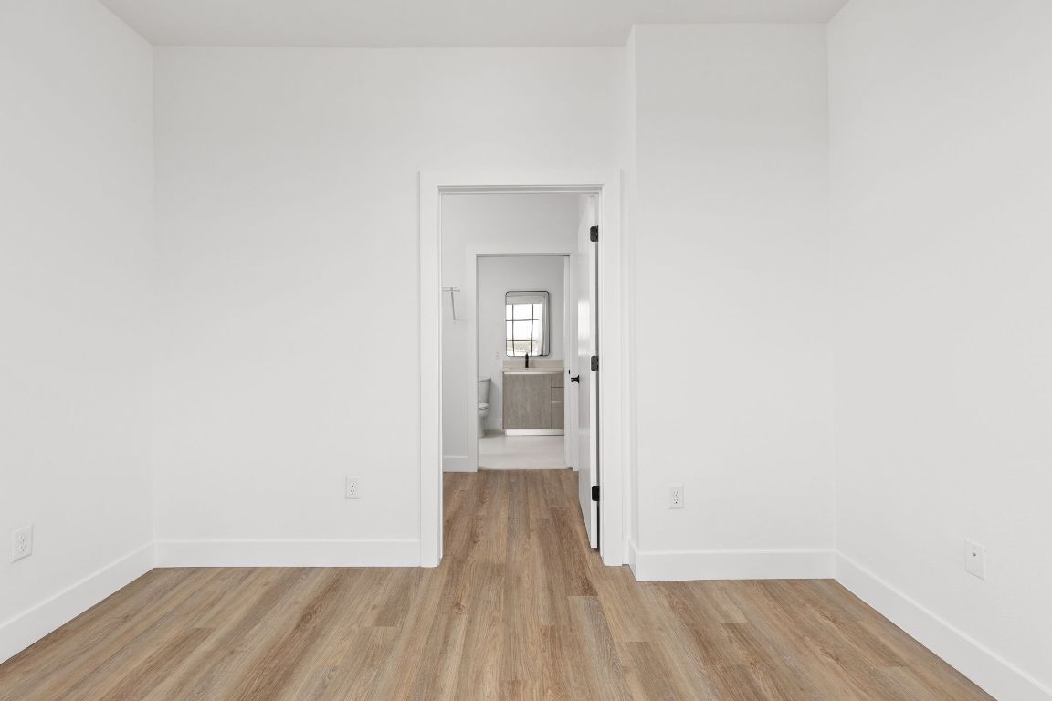 4315 South Congress Avenue, Unit 523 Austin, TX 78745 - Photo 6 of 32 a view of a room with wooden floor and a bathroom