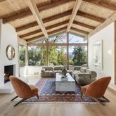 a living room with furniture a fireplace and a large window