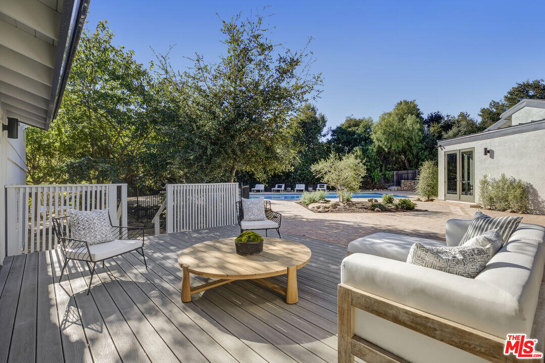 545 Del Oro Drive Ojai, CA 93023 - Photo 22 of 67 a view of a patio with couches table and chairs and potted plants with sky view