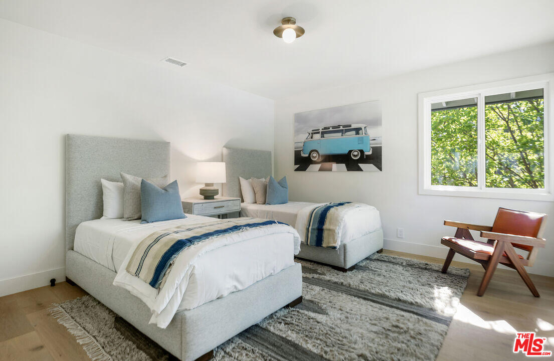 545 Del Oro Drive Ojai, CA 93023 - Photo 42 of 67 a bedroom with a bed and a chair