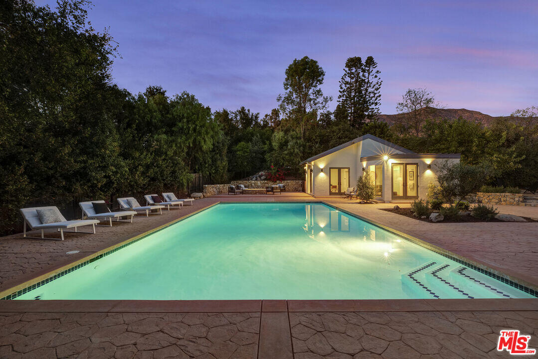 545 Del Oro Drive Ojai, CA 93023 - Photo 54 of 67 a view of a swimming pool with lawn chairs and a yard