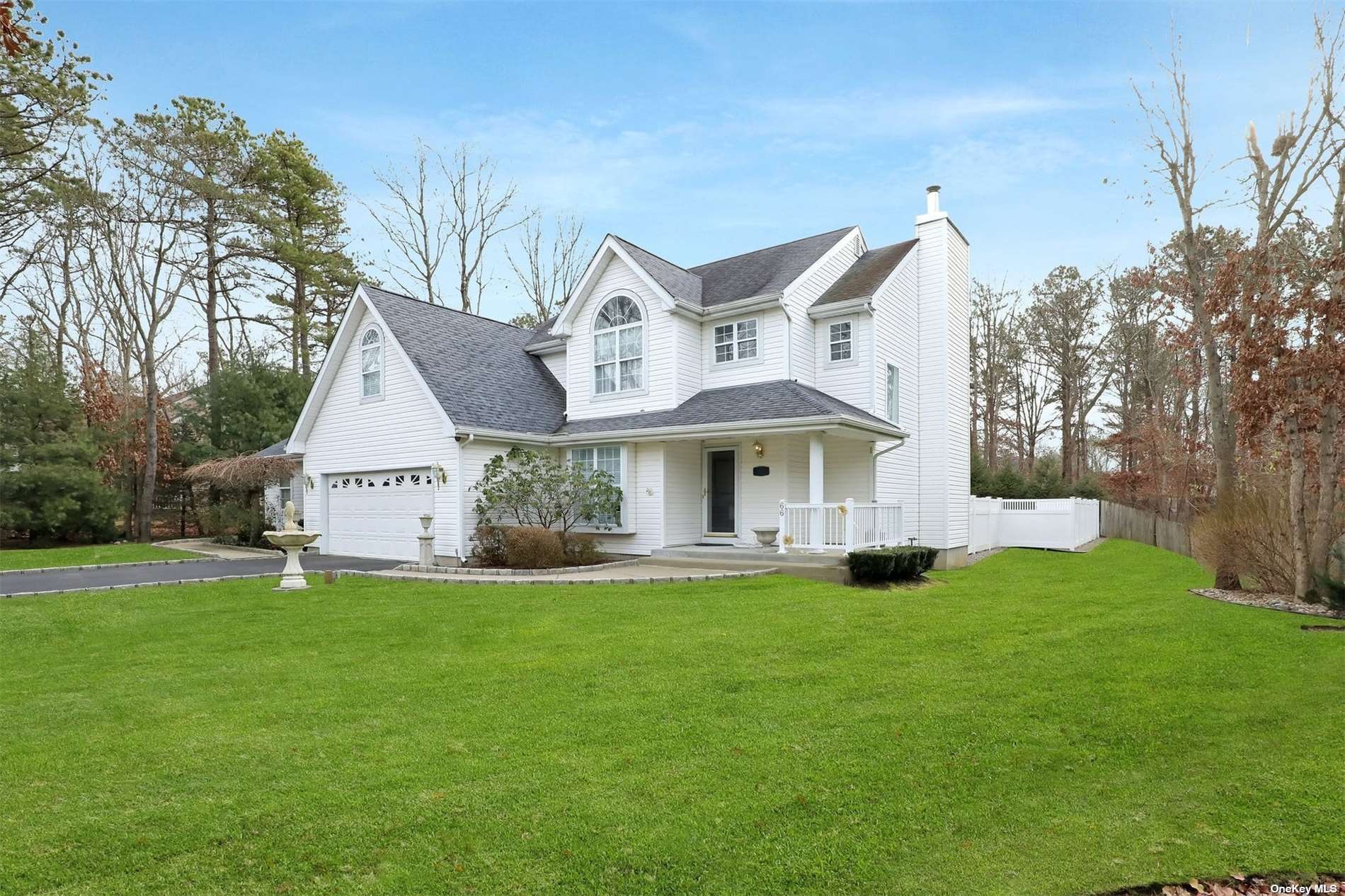 66 Gull Dip Road Ridge, NY 11961 - Photo 1 of 1 a view of a house with a big yard and large trees