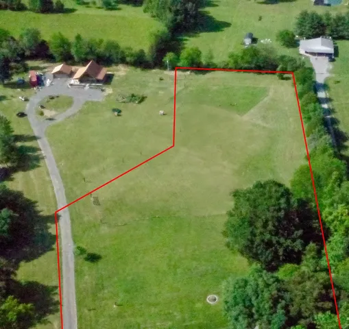 a backyard of a house with a yard and outdoor seating
