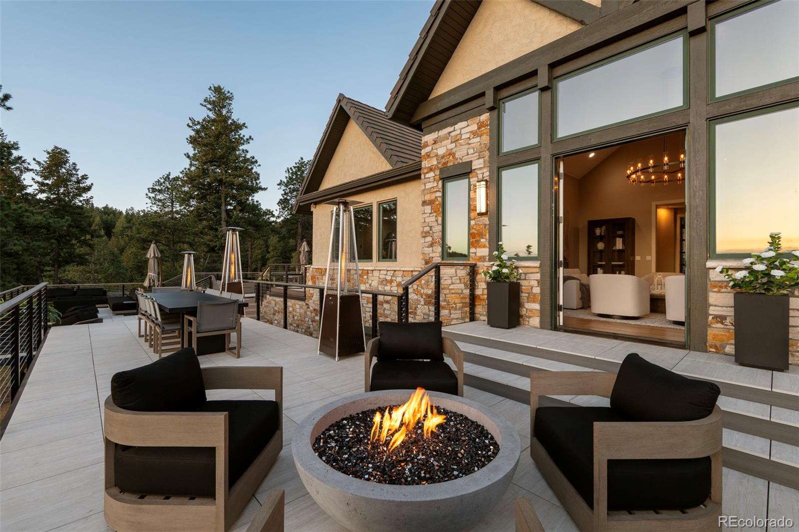 730 Genesee Mountain Road Golden, CO 80401 - Photo 40 of 50 a view of a patio with couches table and chairs and potted plants