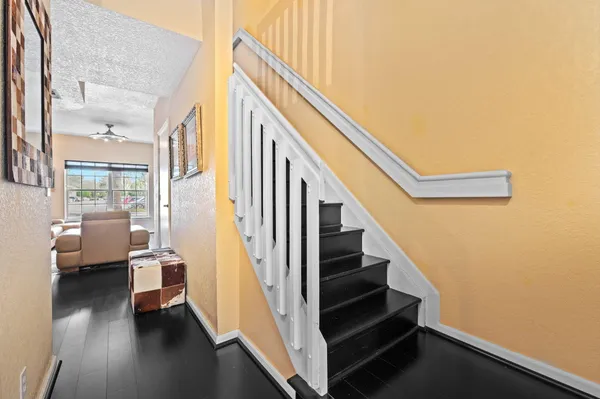 a view of entryway and hall with wooden floor