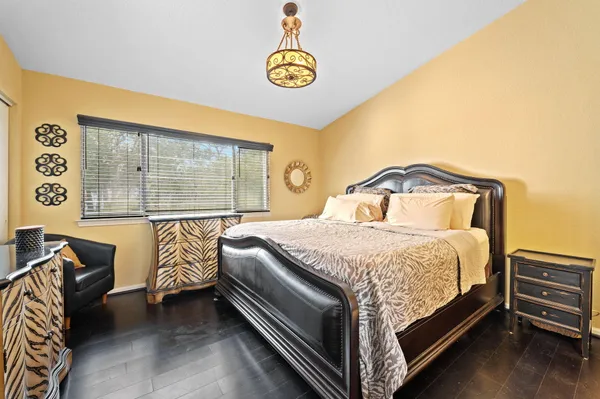 a bed sitting in a bedroom next to a window