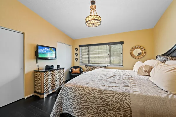 a bedroom with a bed and a chandelier