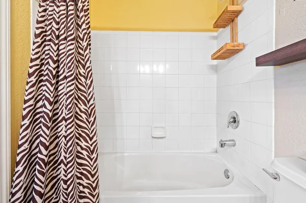 a bathroom with a bathtub and a shower