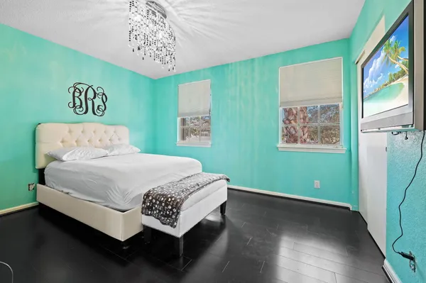 a bedroom with a large bed and a window