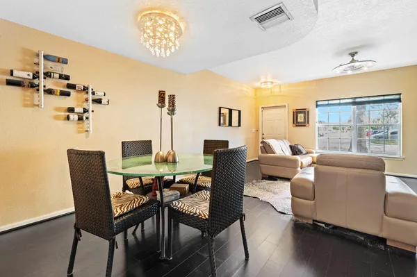 a dining room with furniture a window and wooden floor