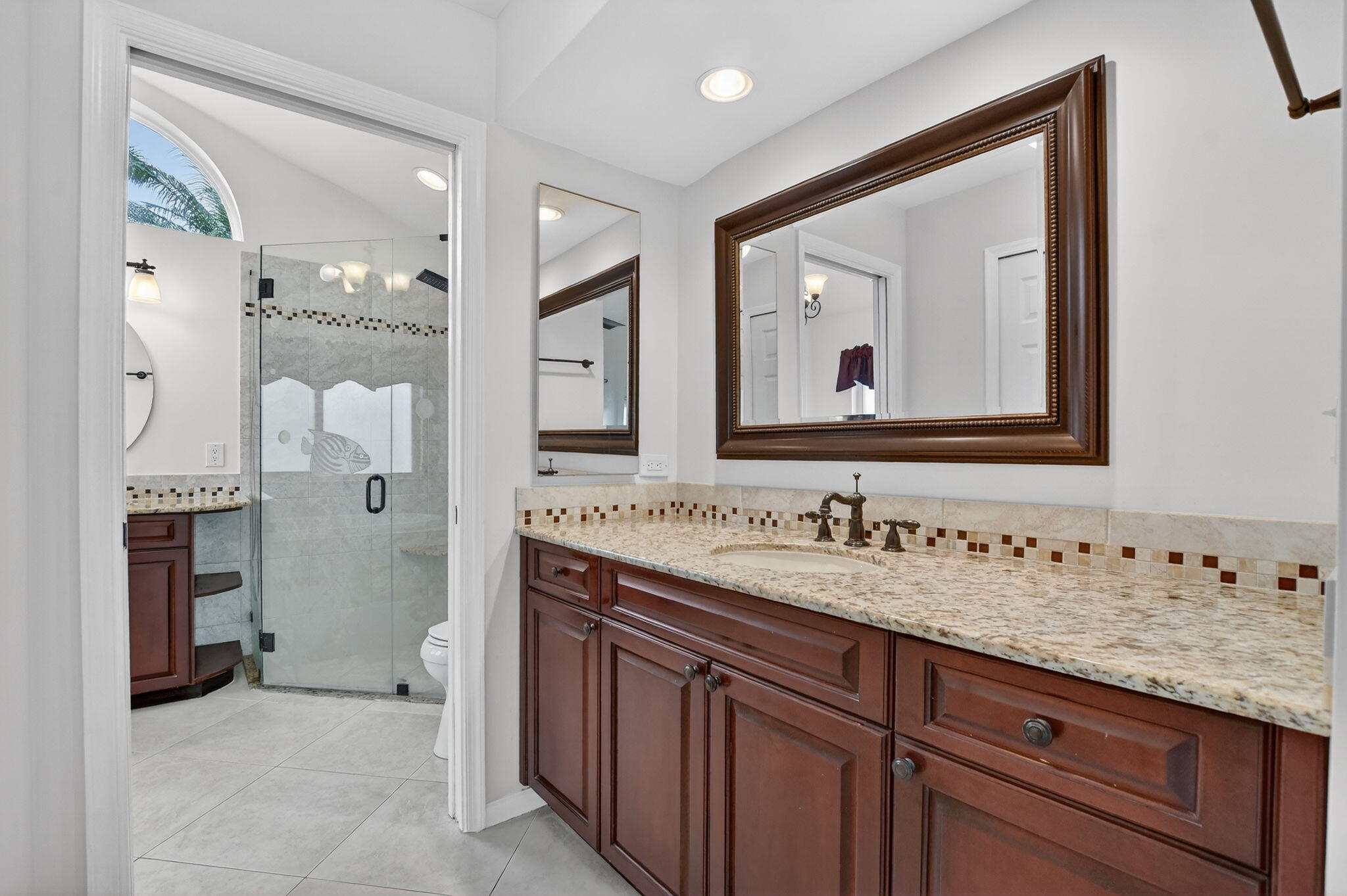 10194 Canoe Brook Circle Boca Raton, FL 33498 - Photo 14 of 42 a bathroom with a granite countertop sink mirror and a