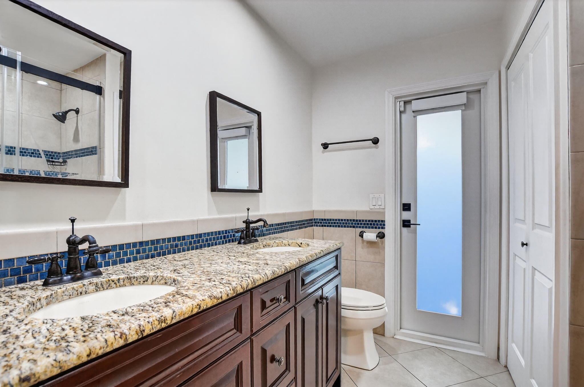10194 Canoe Brook Circle Boca Raton, FL 33498 - Photo 26 of 42 a bathroom with a granite countertop toilet a sink and a mirror