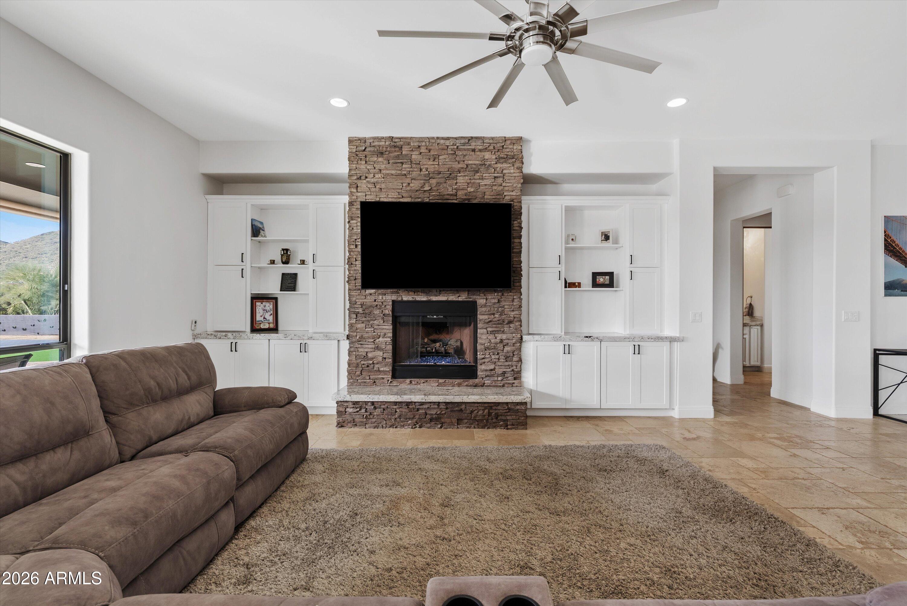 1617 West Maddock Road Phoenix, AZ 85086 - Photo 9 of 50 a living room with furniture a flat screen tv and a fireplace