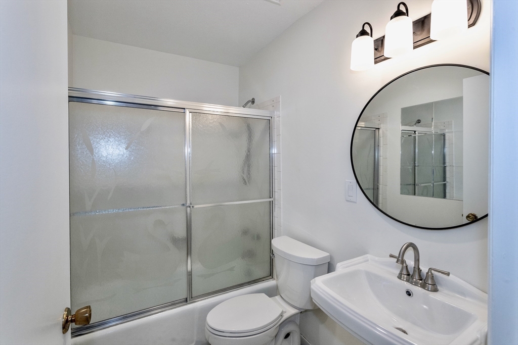 324 Russell Road, Unit 204 Westfield, MA 01085 - Photo 18 of 31 a bathroom with a toilet sink and mirror