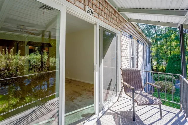 a view of a room with a floor to ceiling windows with wooden floor