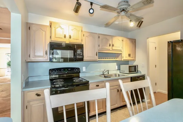 a kitchen with stainless steel appliances a stove a sink and a refrigerator