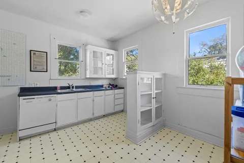 a kitchen with granite countertop a refrigerator and a sink