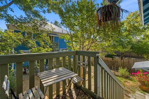 a view of a balcony with wooden floor and outdoor seating
