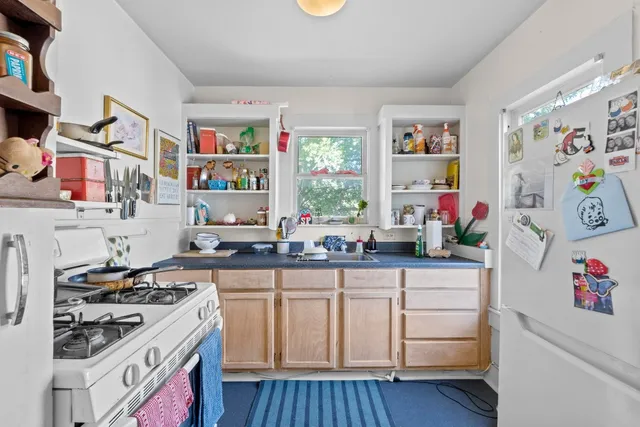 a kitchen with cabinets and window