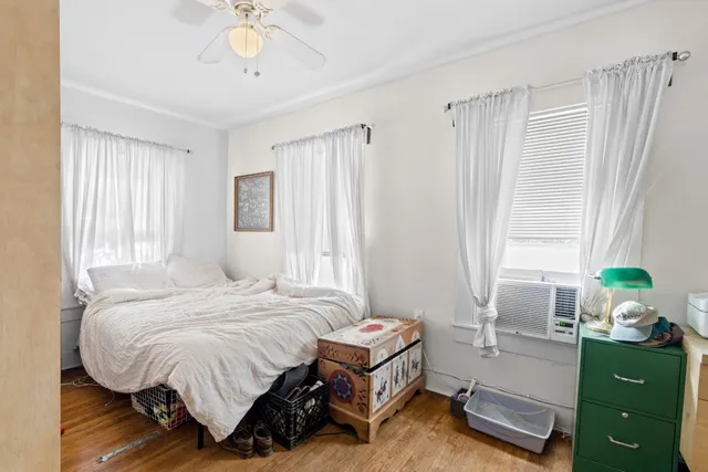 a bedroom with a bed dresser and a window