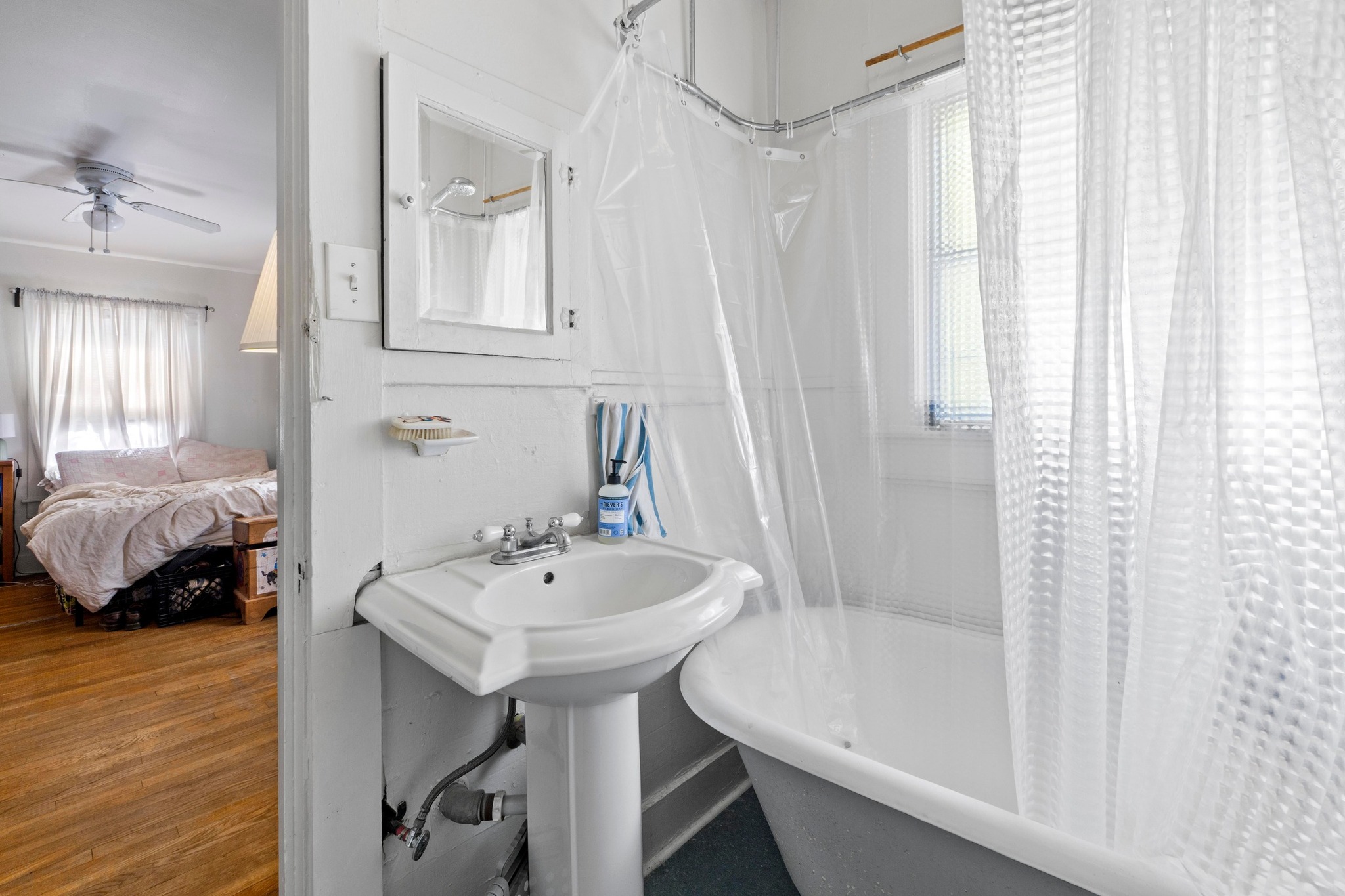 4014 Avenue D Austin, TX 78751 - Photo 33 of 34 a bathroom with a sink a mirror and a bathtub