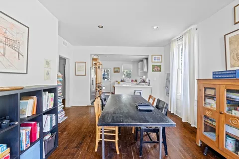 a view of a dining room with furniture and a book shelf