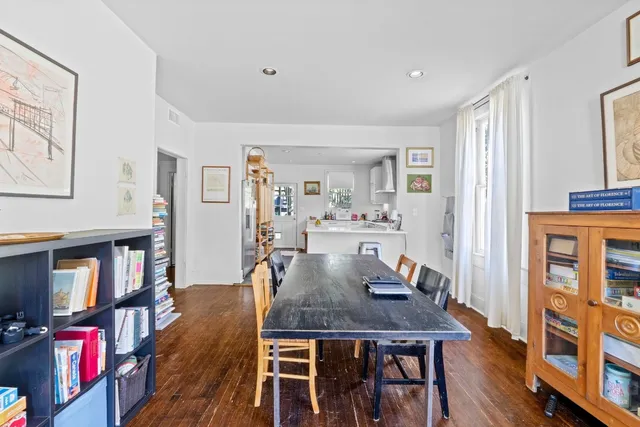a view of a dining room with furniture and a book shelf