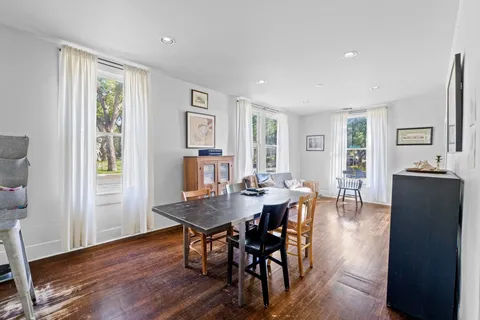 a view of a dining room with furniture and wooden floor