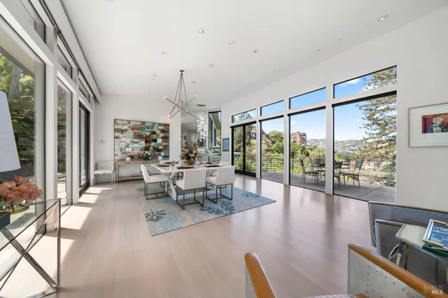 a living room with furniture and floor to ceiling windows