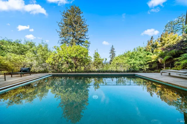 a view of a dining room with furniture a chandelier and wooden floor