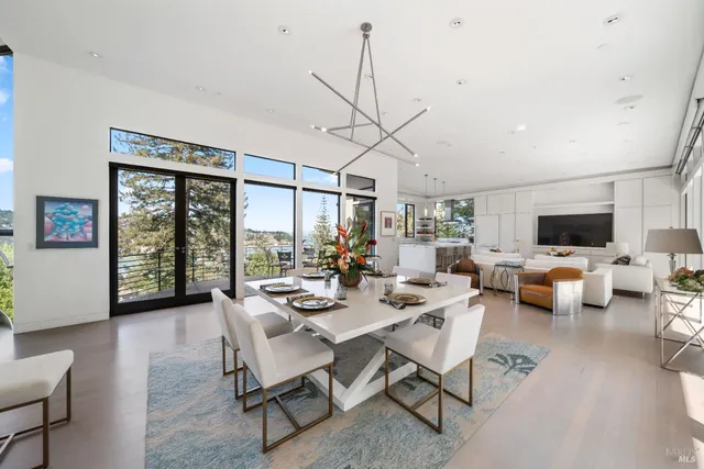 a large white kitchen with a large window and stainless steel appliances