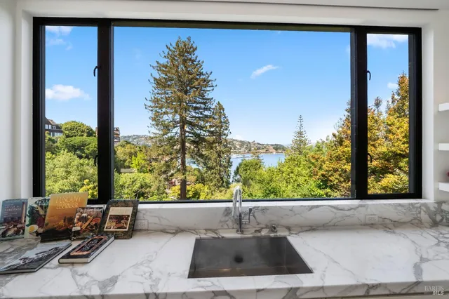a spacious bedroom with a bed couch and a large window