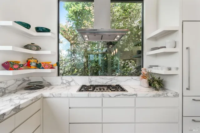 a bedroom with a bed and large windows