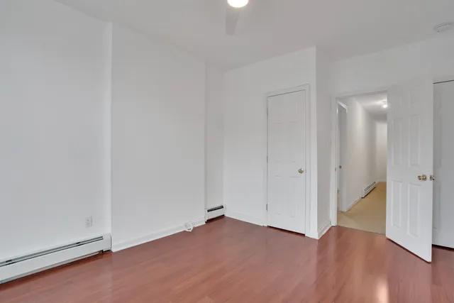 a view of an empty room and wooden floor