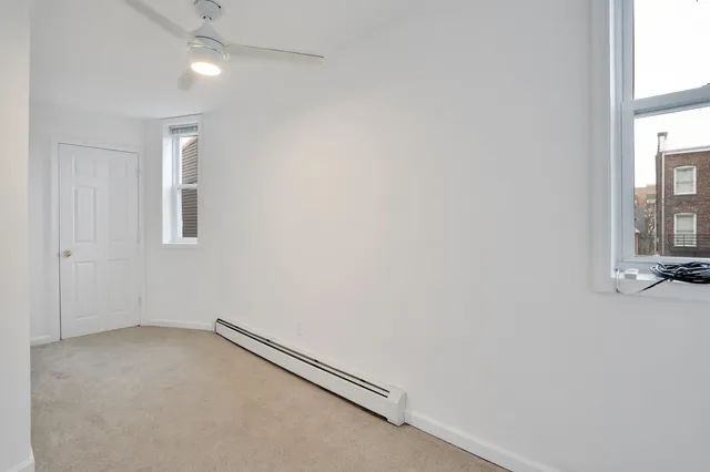 an empty room with a empty space and windows