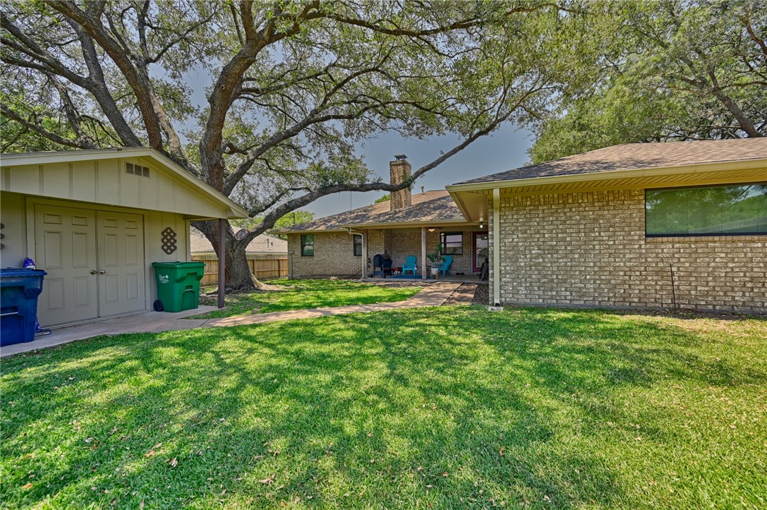 1600 Pecan Street Brenham, TX 77833 - Photo 31 of 33 View of backyard, concrete side walk, outbuilding and garage
