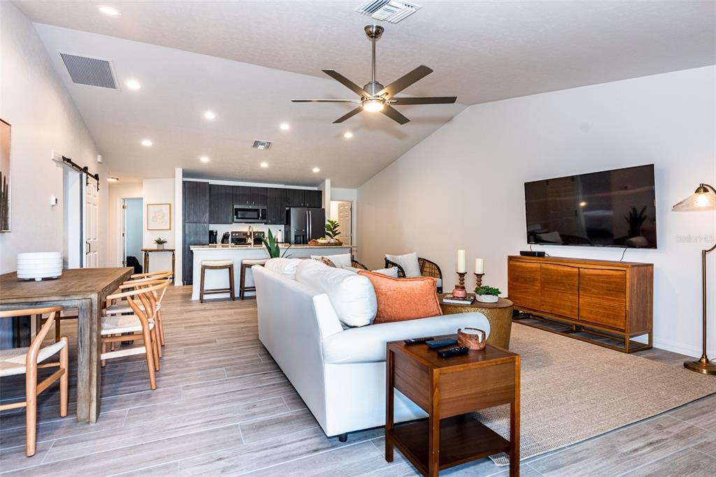 219 Lewis Circle, Unit 112 Punta Gorda, FL 33950 - Photo 12 of 36 a living room with furniture and a flat screen tv