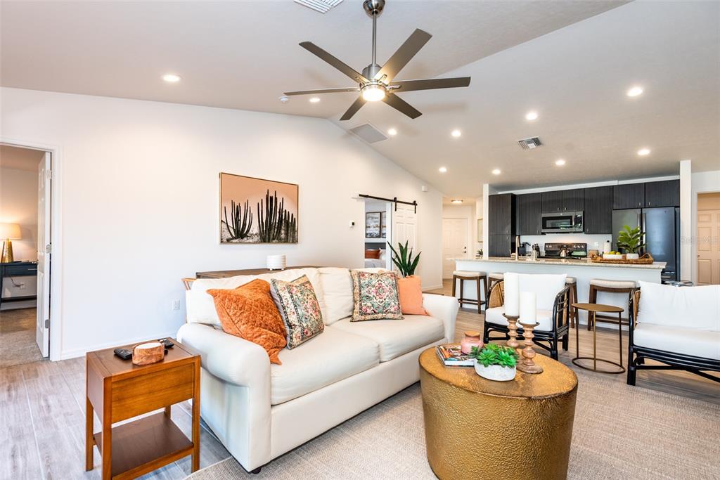 219 Lewis Circle, Unit 112 Punta Gorda, FL 33950 - Photo 13 of 36 a living room with furniture kitchen view and a potted plant
