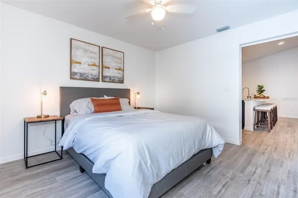 a bedroom with a large bed and a chandelier