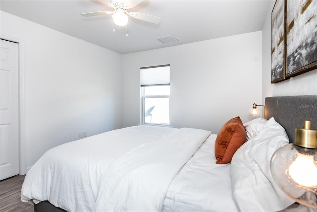 219 Lewis Circle, Unit 112 Punta Gorda, FL 33950 - Photo 19 of 36 a bedroom with a bed and a window