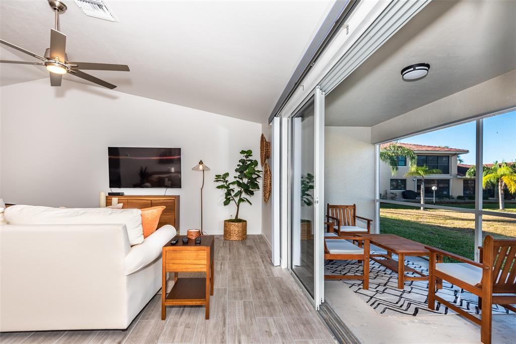 219 Lewis Circle, Unit 112 Punta Gorda, FL 33950 - Photo 20 of 36 a living room with furniture and a flat screen tv