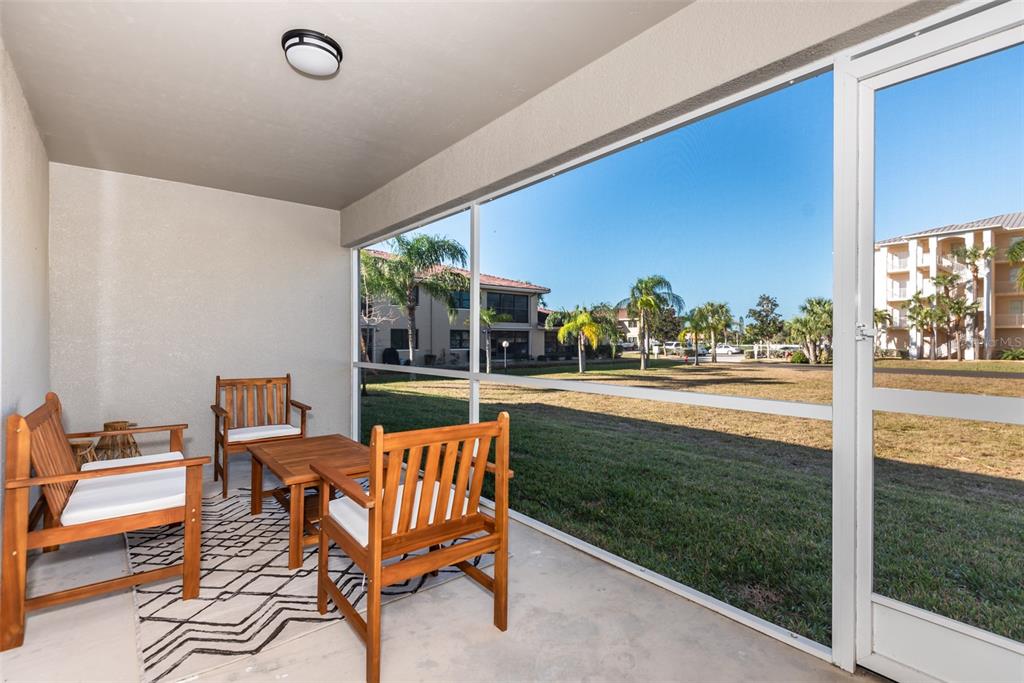 219 Lewis Circle, Unit 112 Punta Gorda, FL 33950 - Photo 21 of 36 a living room with patio furniture and a floor to ceiling window