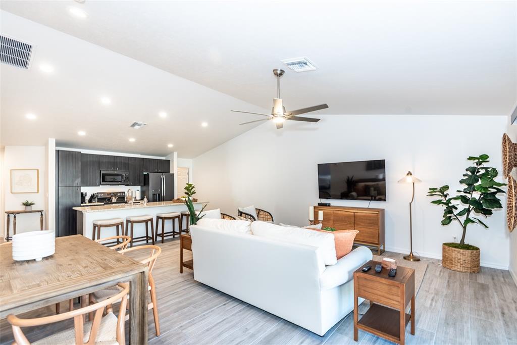 219 Lewis Circle, Unit 112 Punta Gorda, FL 33950 - Photo 23 of 36 a living room with furniture and a flat screen tv